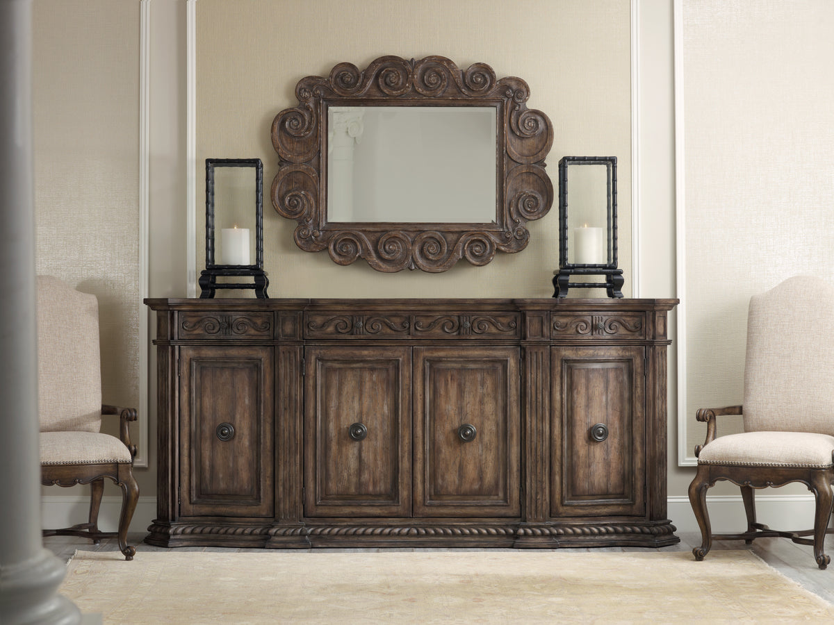 a mirror above a cabinet