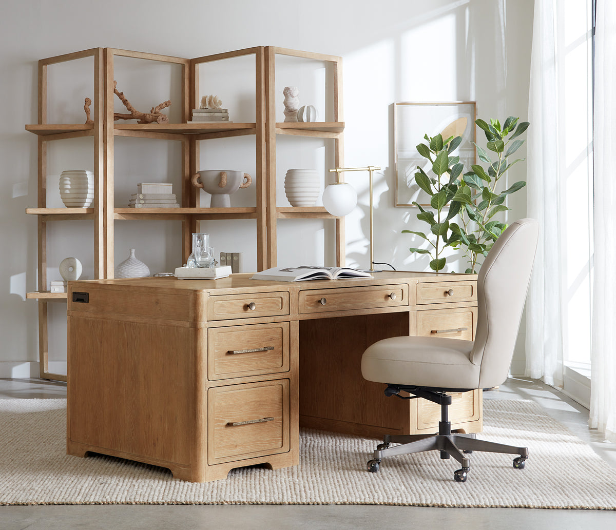 a desk in a room with a chair and shelves