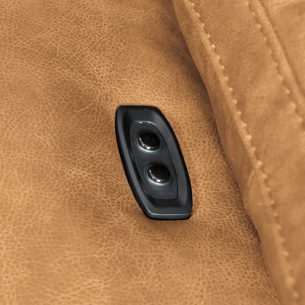 a black object on a brown leather surface