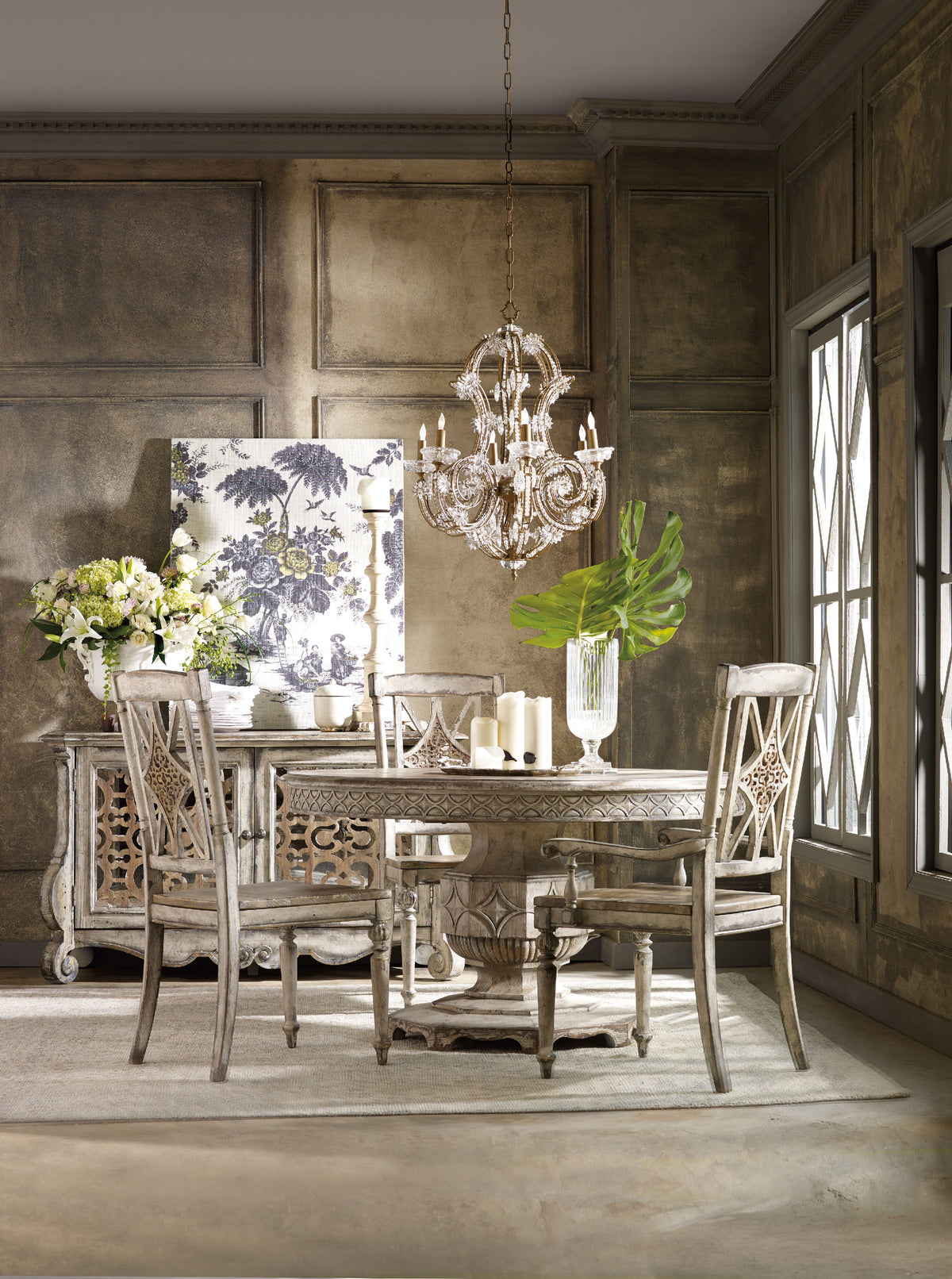 a dining room with a chandelier and table