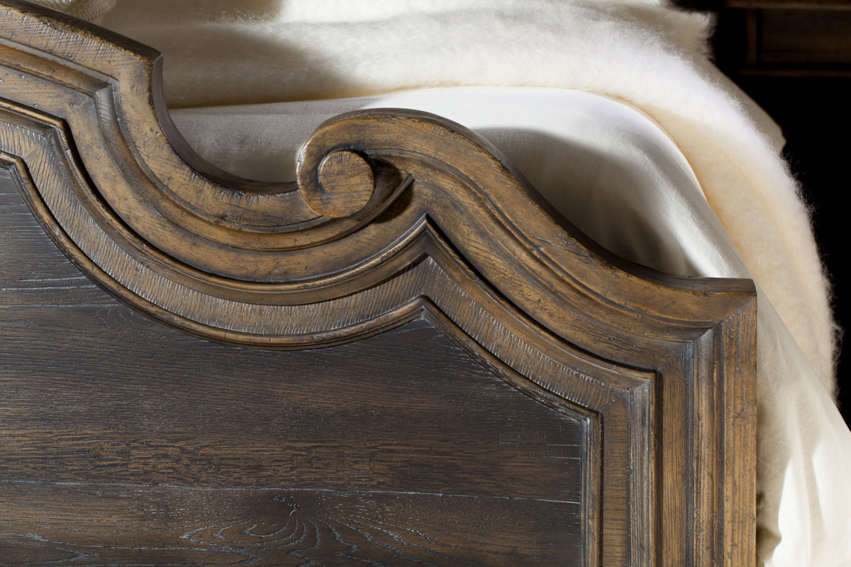 a wood and white blanket on a bed