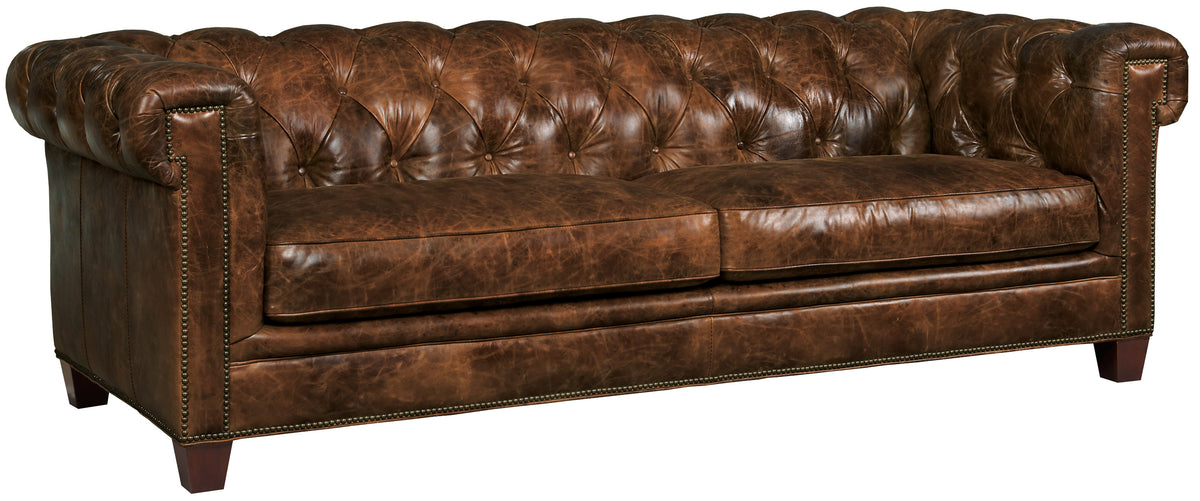 a brown leather couch with buttons