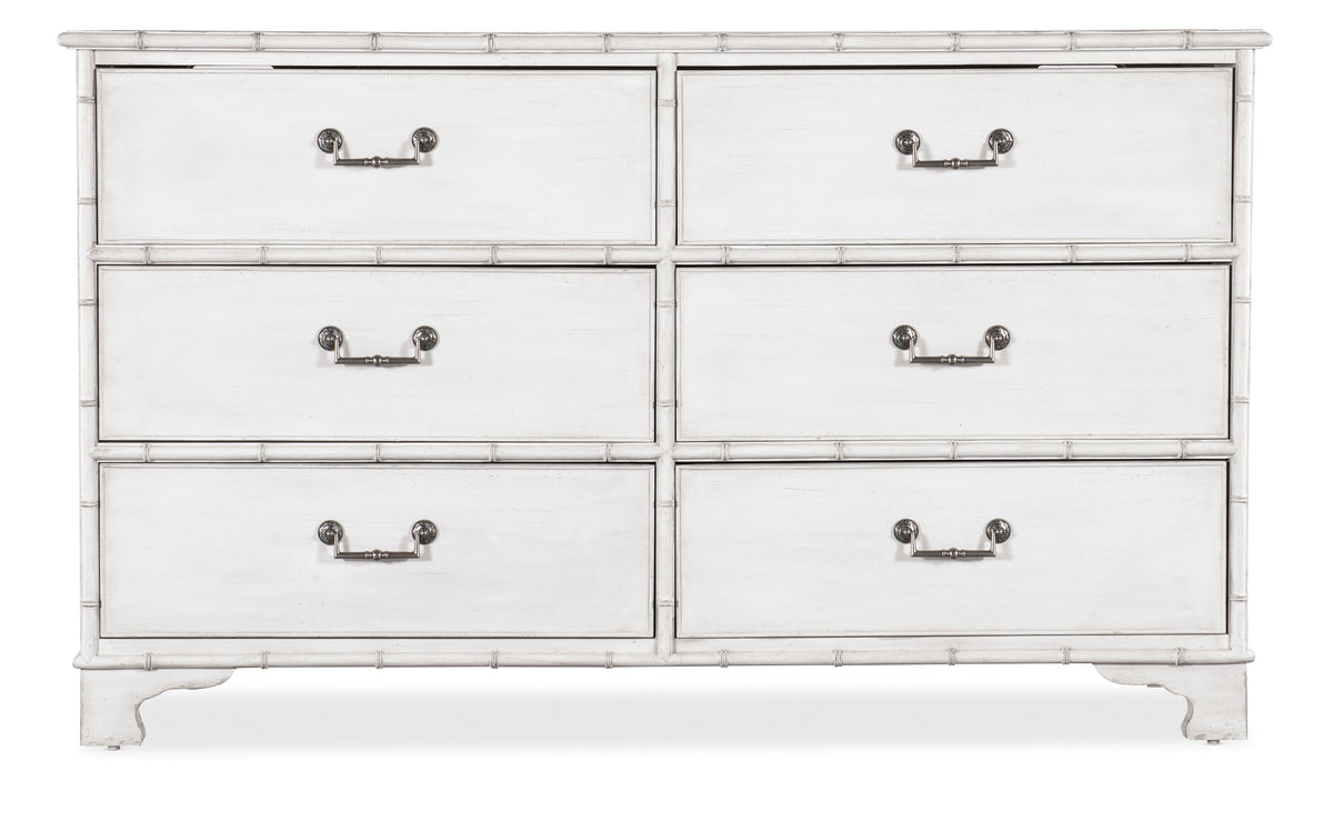 a white dresser with silver handles