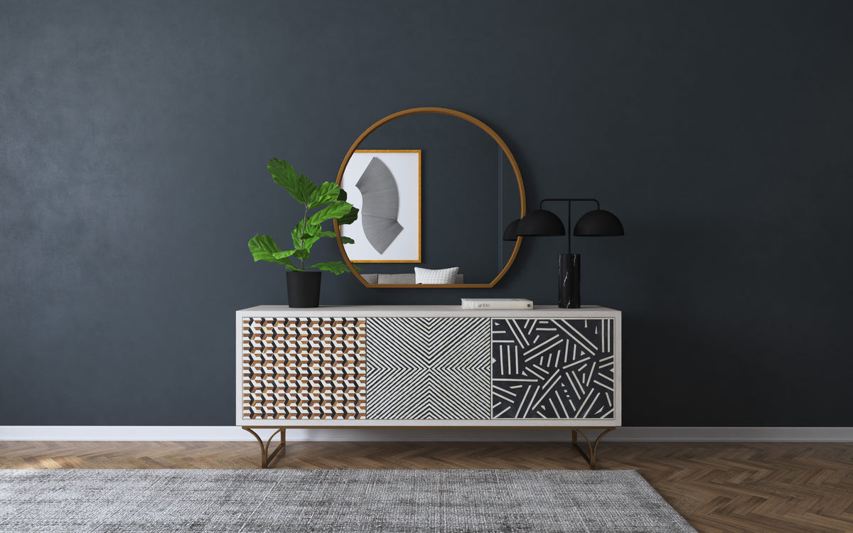 a white cabinet with a mirror and a plant on it