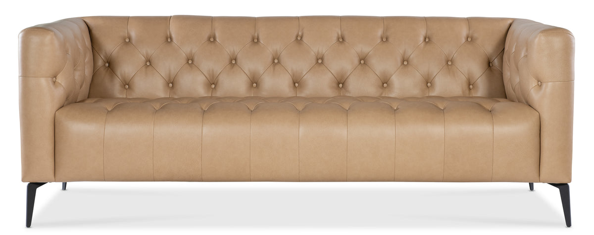 a tan leather couch with buttons