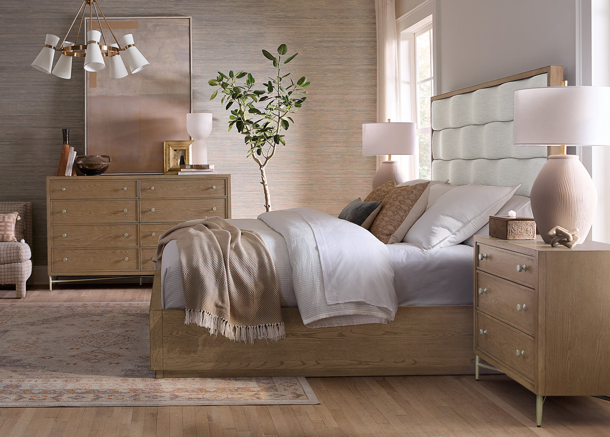 a bedroom with a bed and dressers