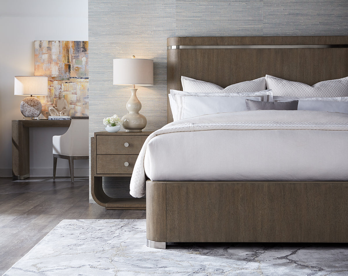 a bed with a lamp next to a desk