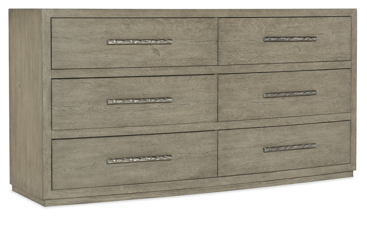 a wooden dresser with silver handles