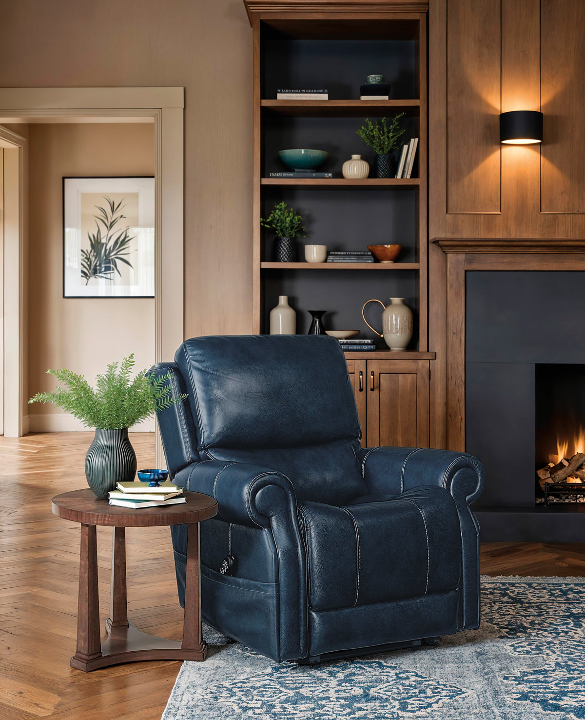 a living room with a fireplace and a blue chair