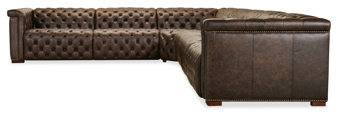 a brown leather couch with gold studs