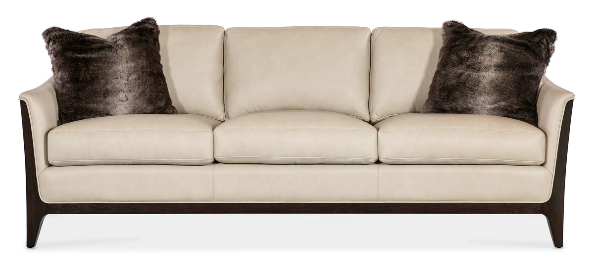 a white couch with brown pillows