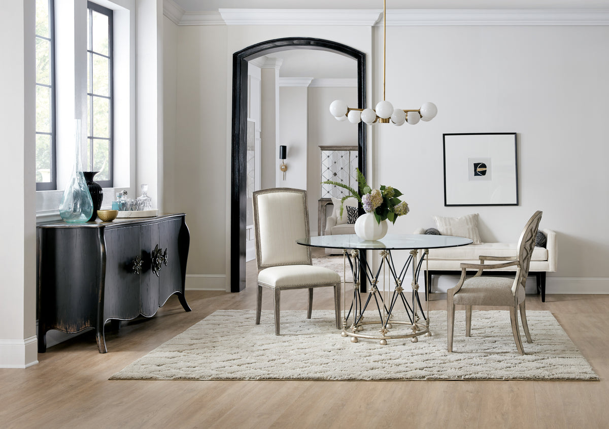 a dining room with a glass table and chairs