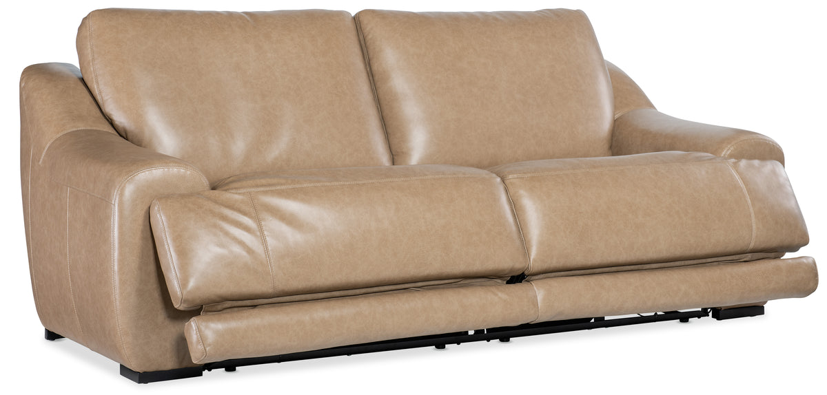 a tan leather couch with black legs
