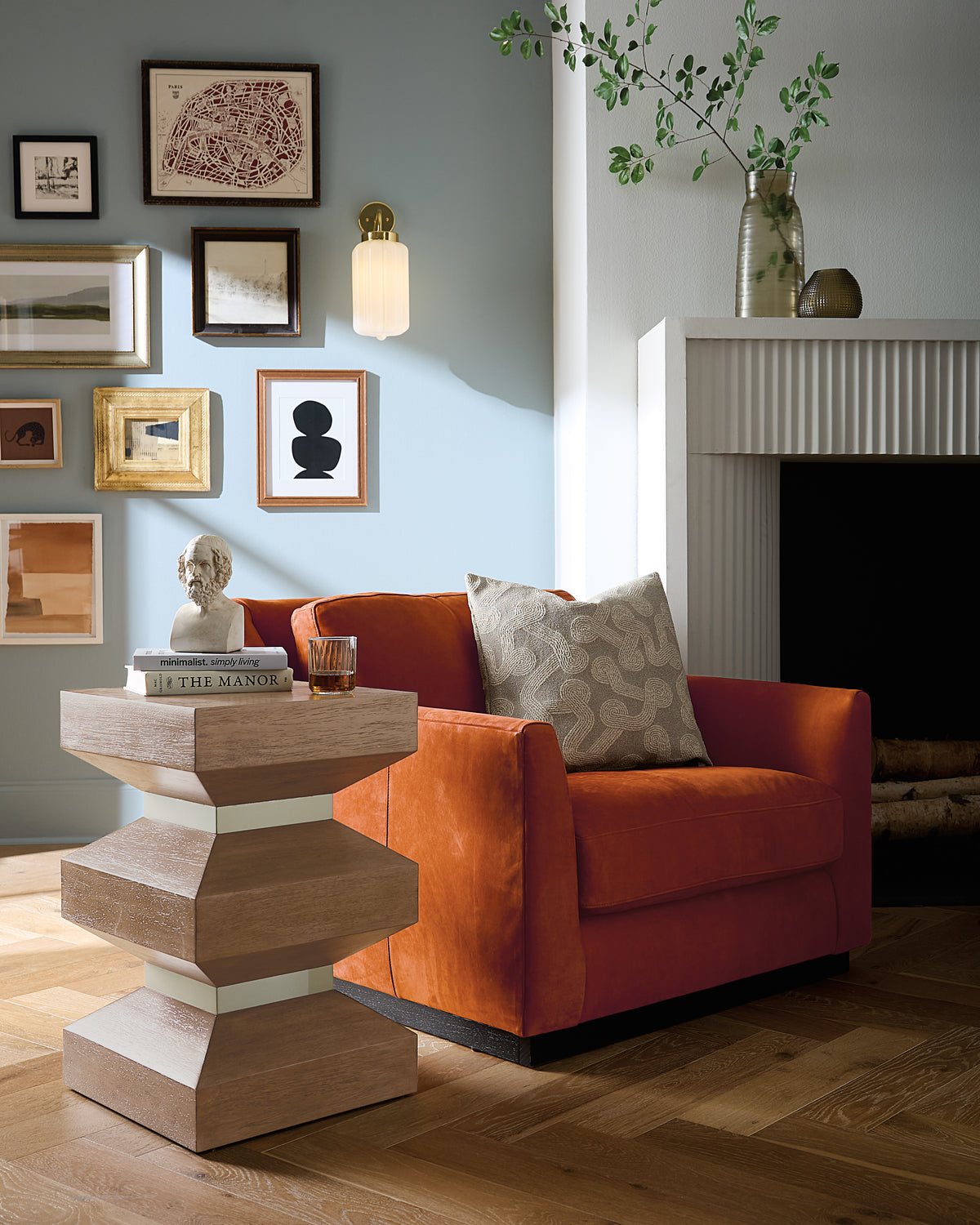a living room with a red chair and a table