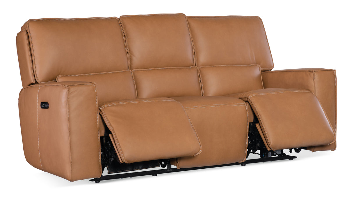 a brown leather couch with armrests