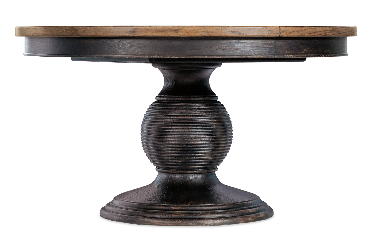 a round wooden table with a round base