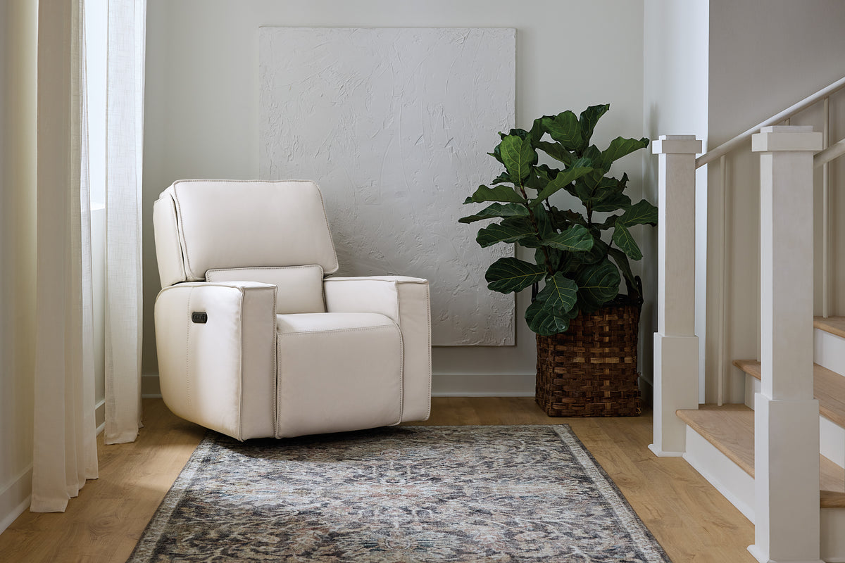 a white chair next to a plant