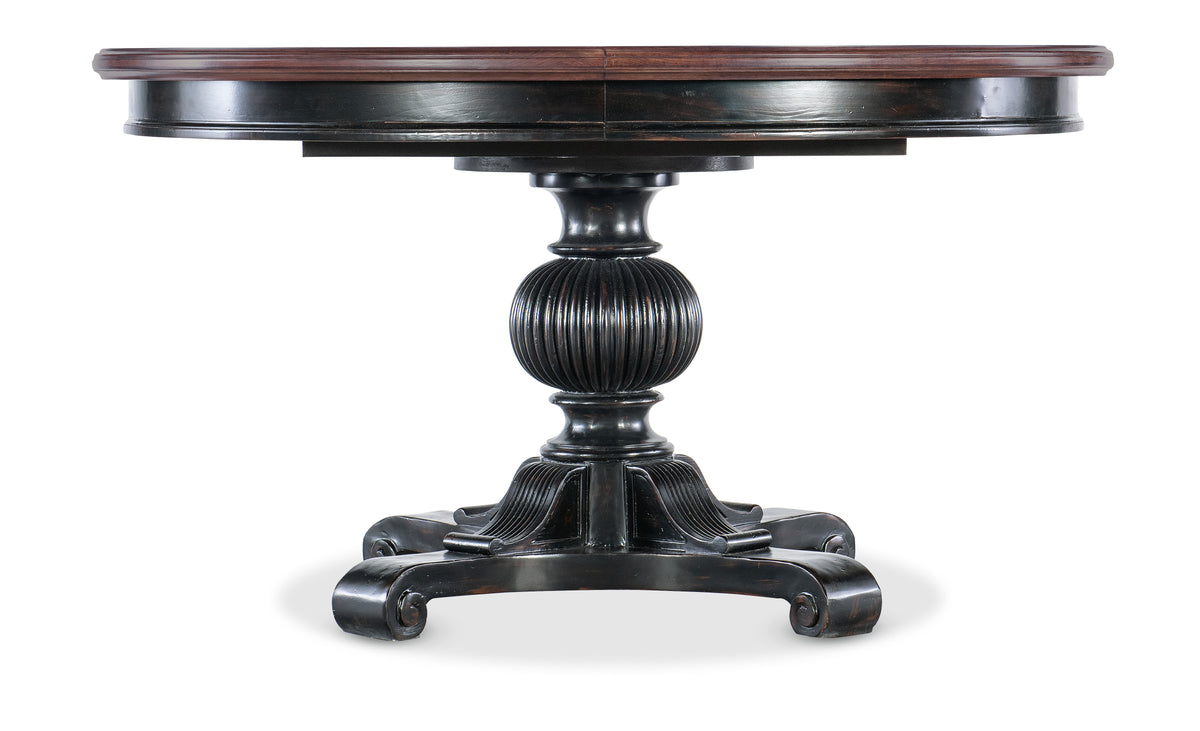 a round wooden table with a pedestal
