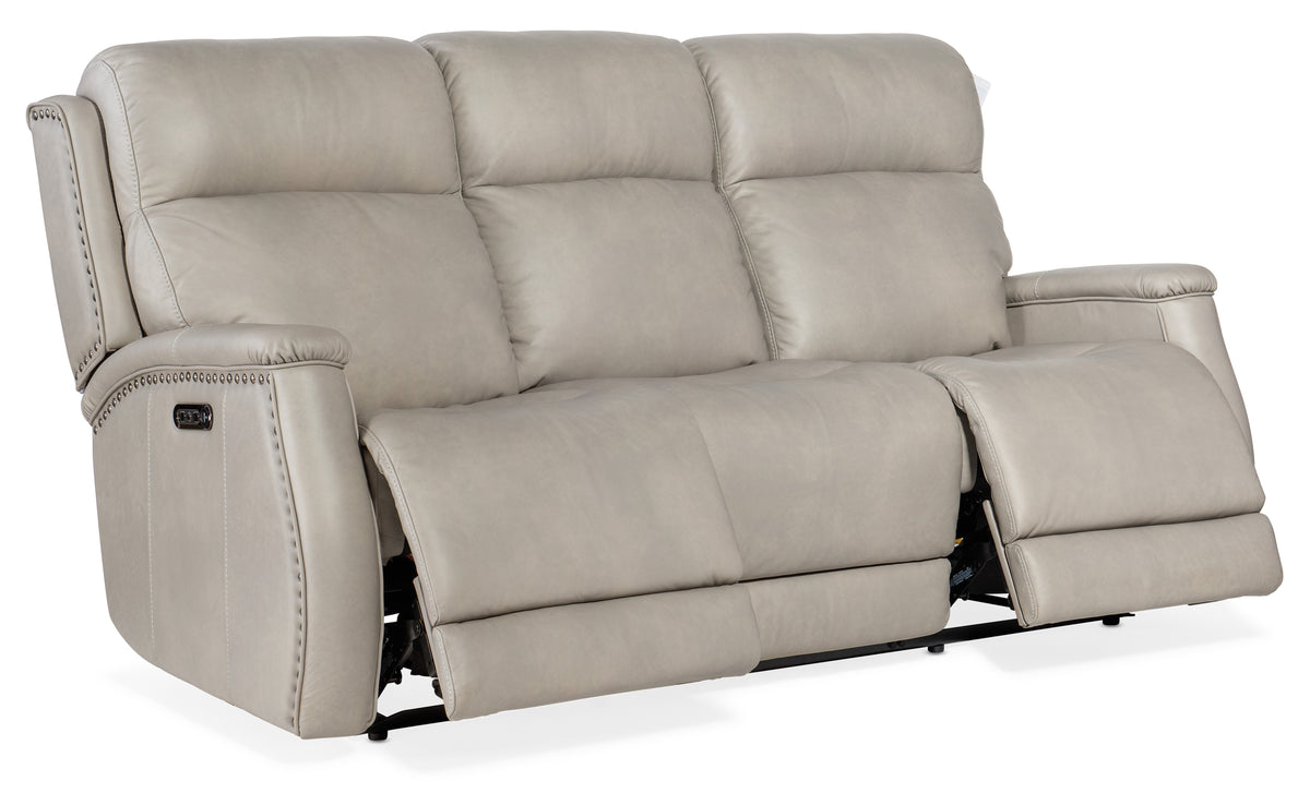 a white leather couch with two recliners