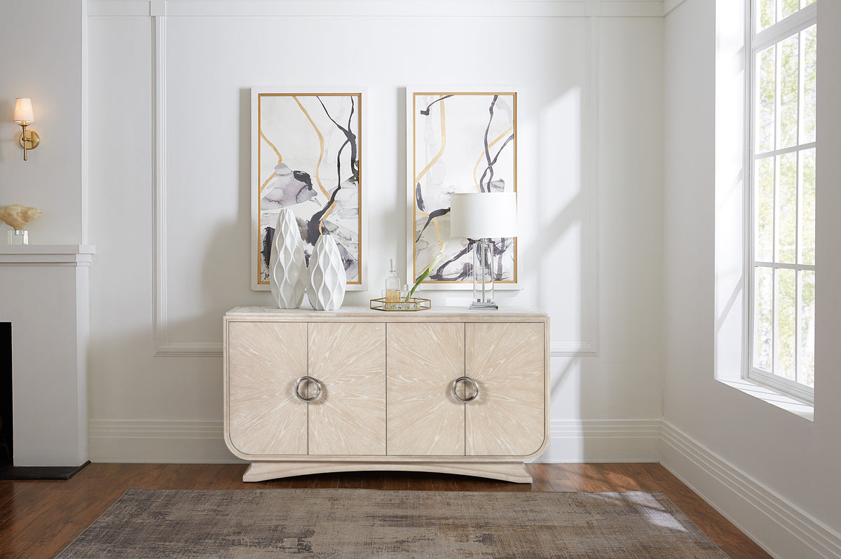 a white dresser with a lamp and a painting on the wall