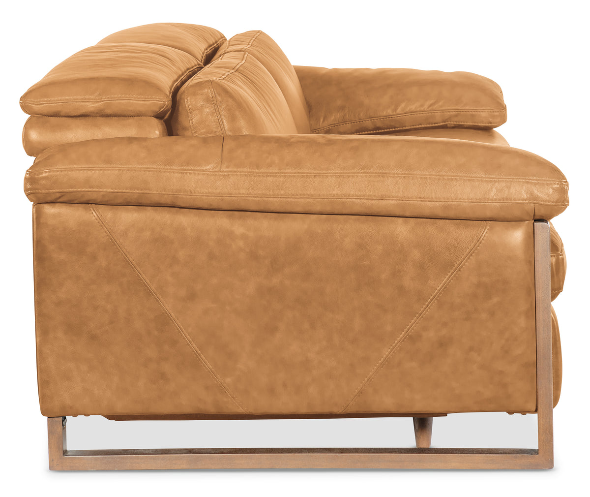 a brown leather couch with wooden legs
