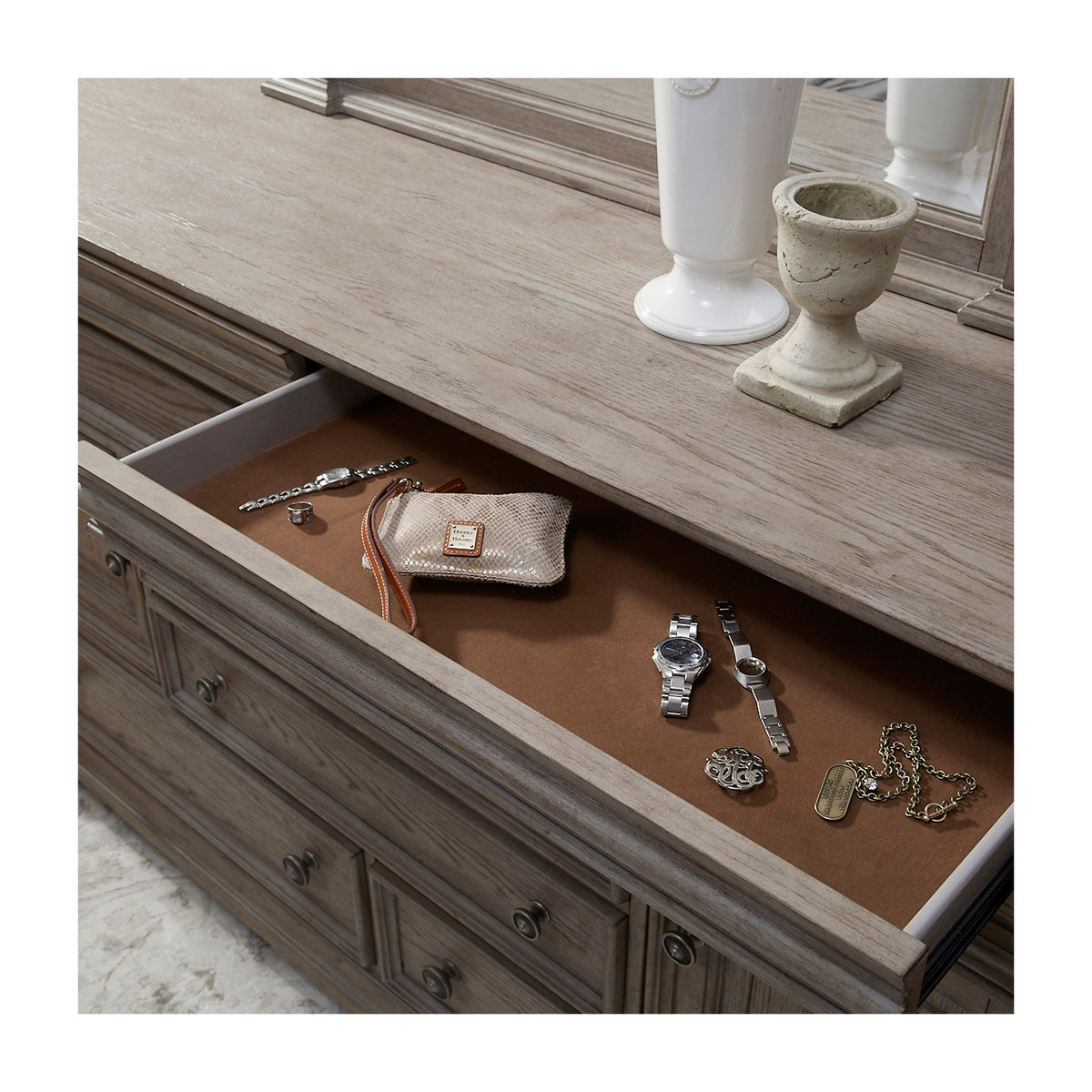 a drawer with jewelry and a purse on it