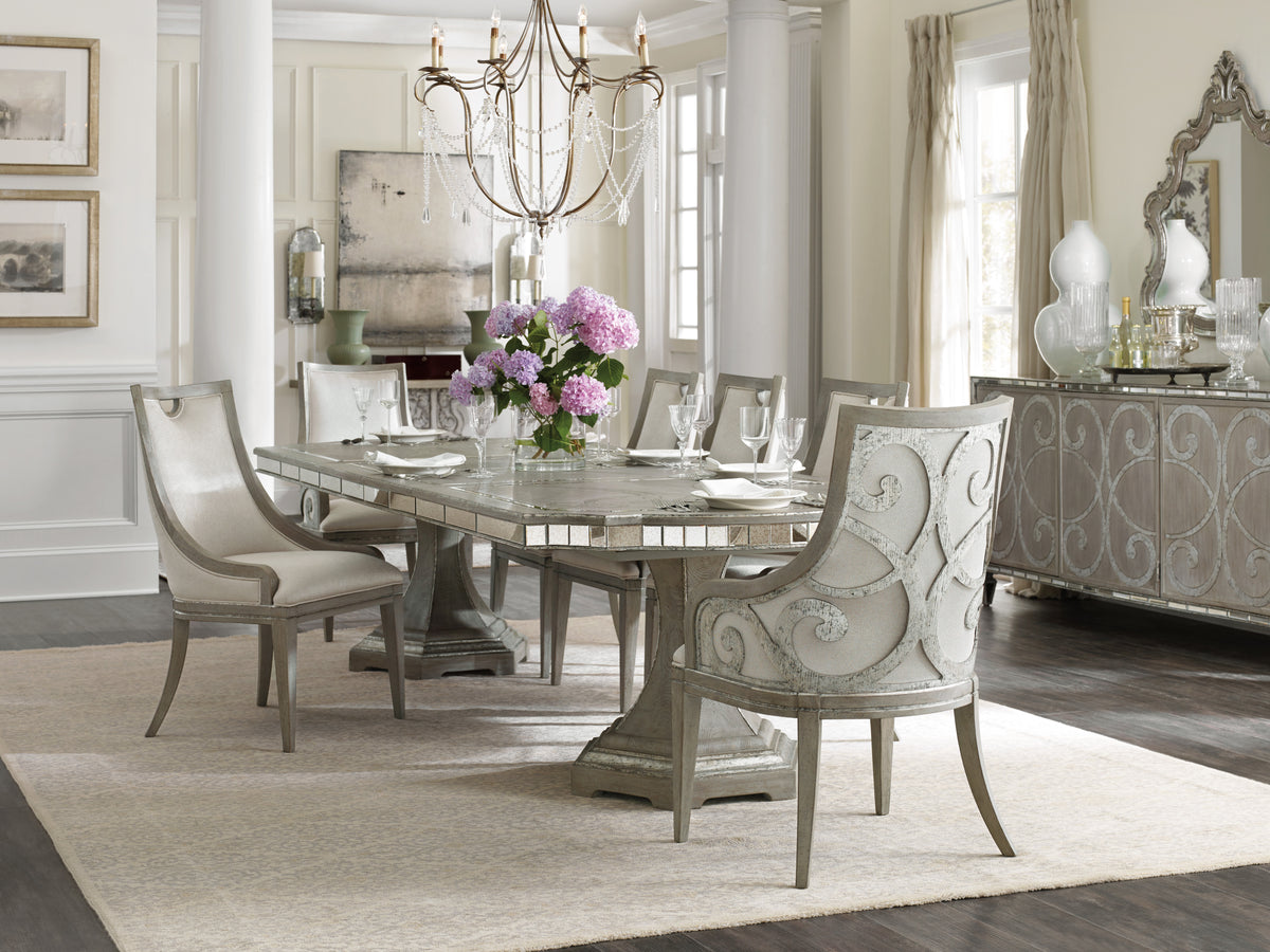 a dining room table with chairs and a chandelier