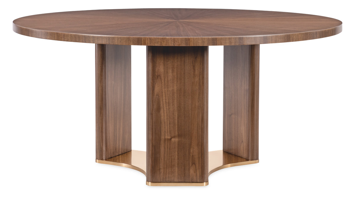 a round wooden table with gold legs