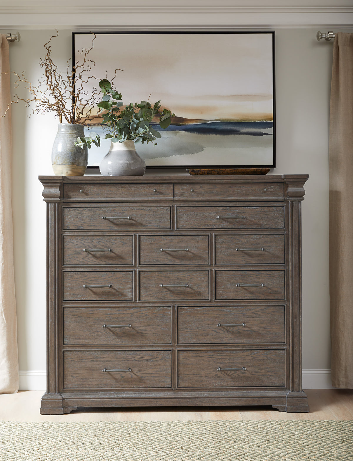 a dresser with a painting on the wall