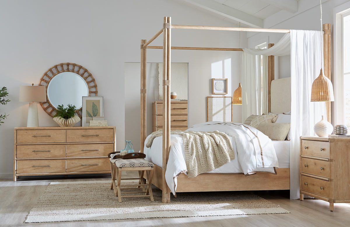 a bedroom with a four poster bed and a dresser