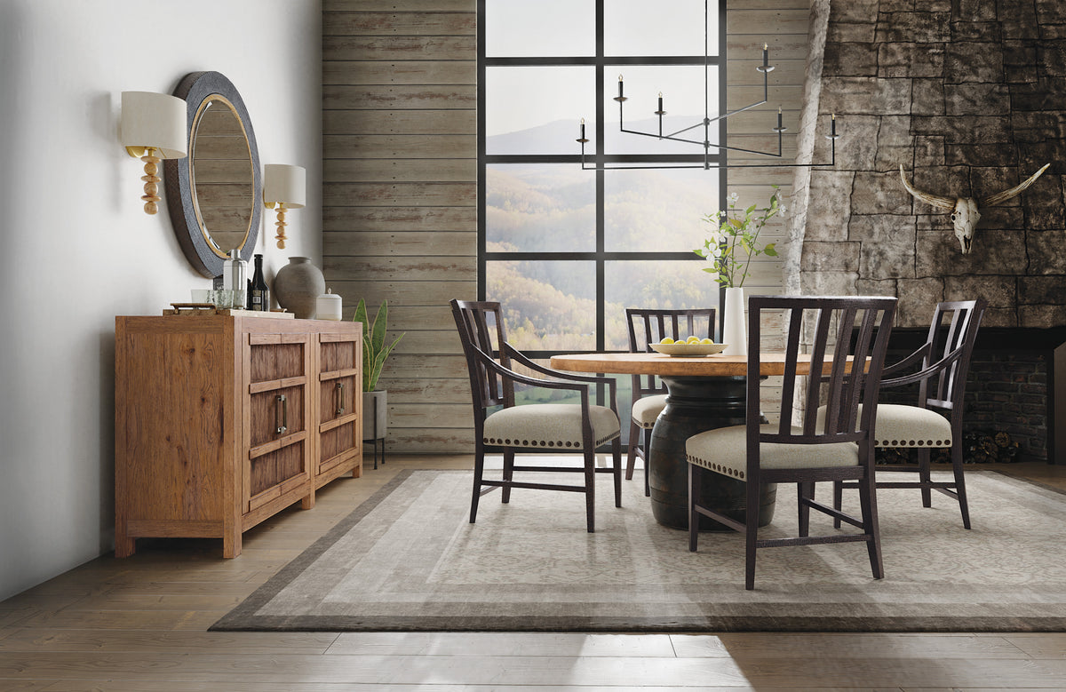 a dining room with a round table and chairs