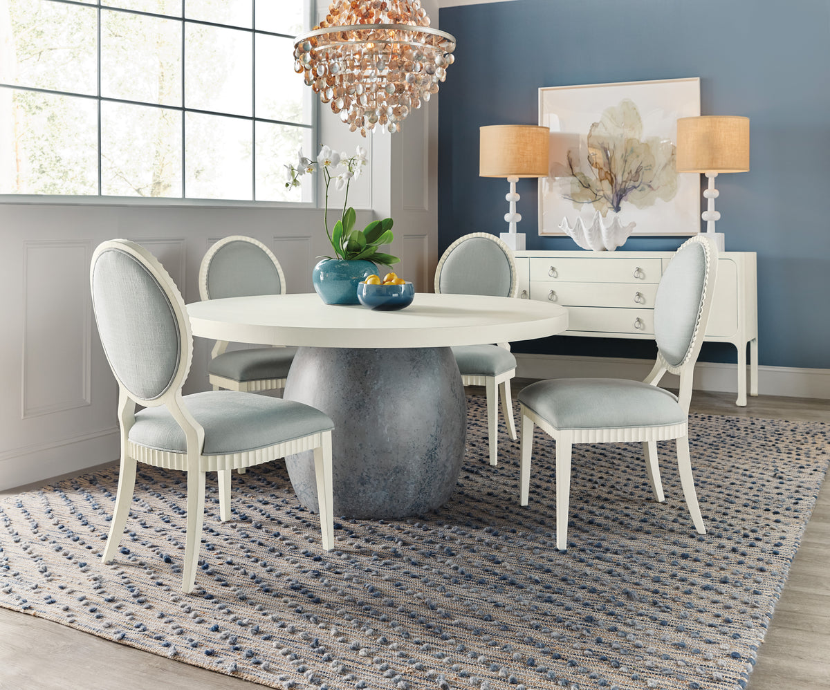 a dining room table with chairs and a chandelier