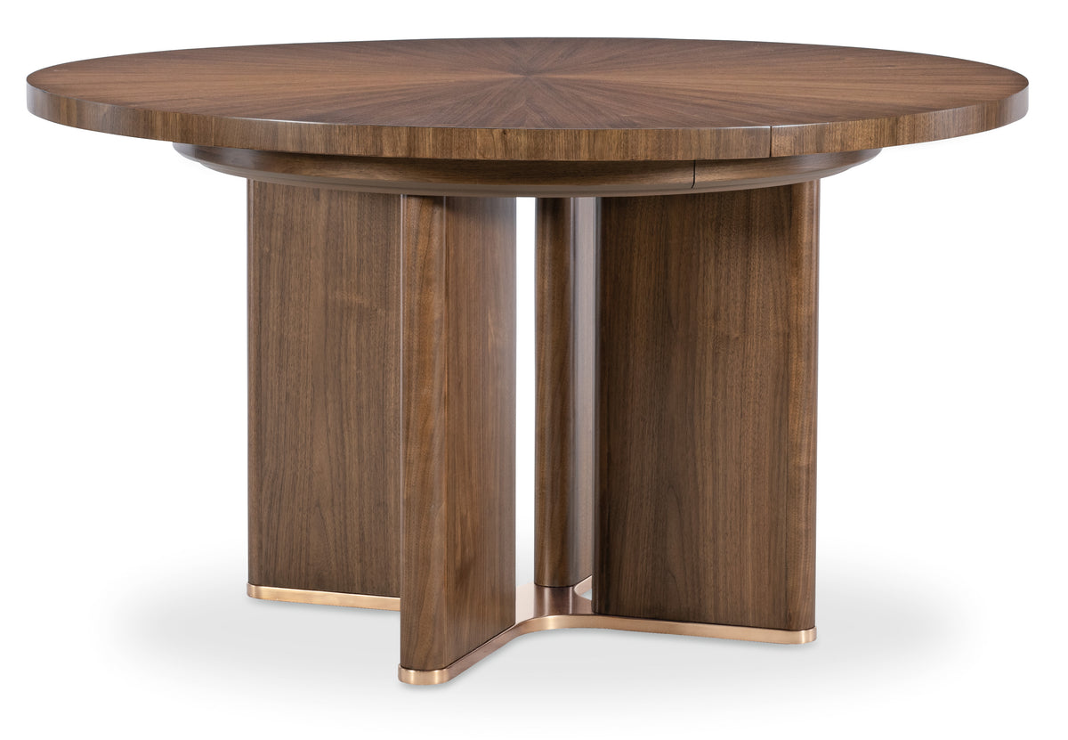 a round wooden table with gold legs
