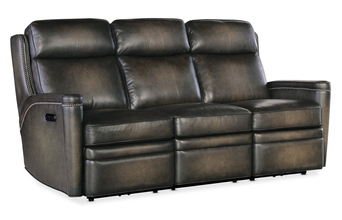 a brown leather couch with four reclining seats