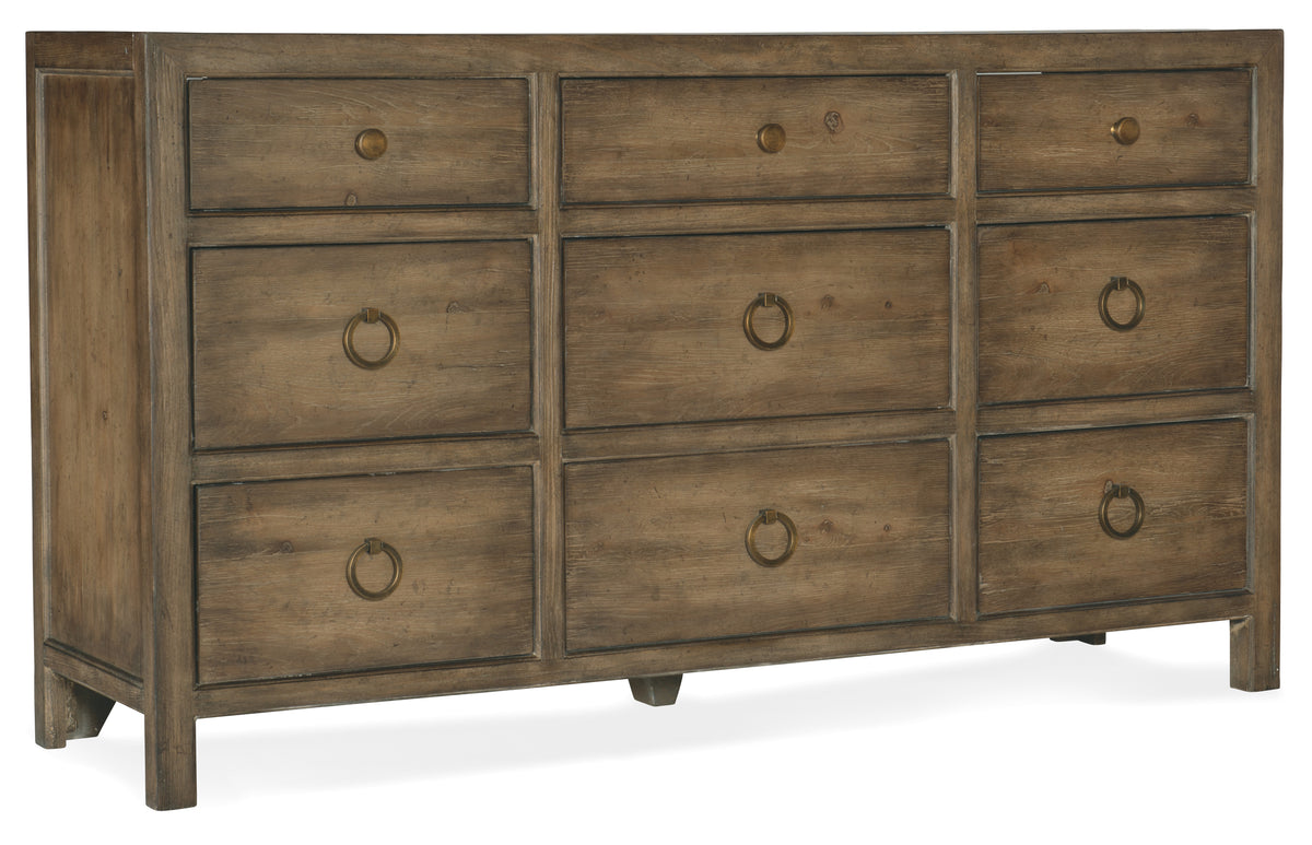 a wooden dresser with gold handles