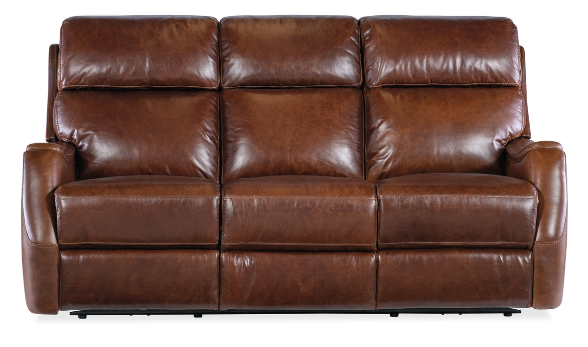 a brown leather couch with buttons