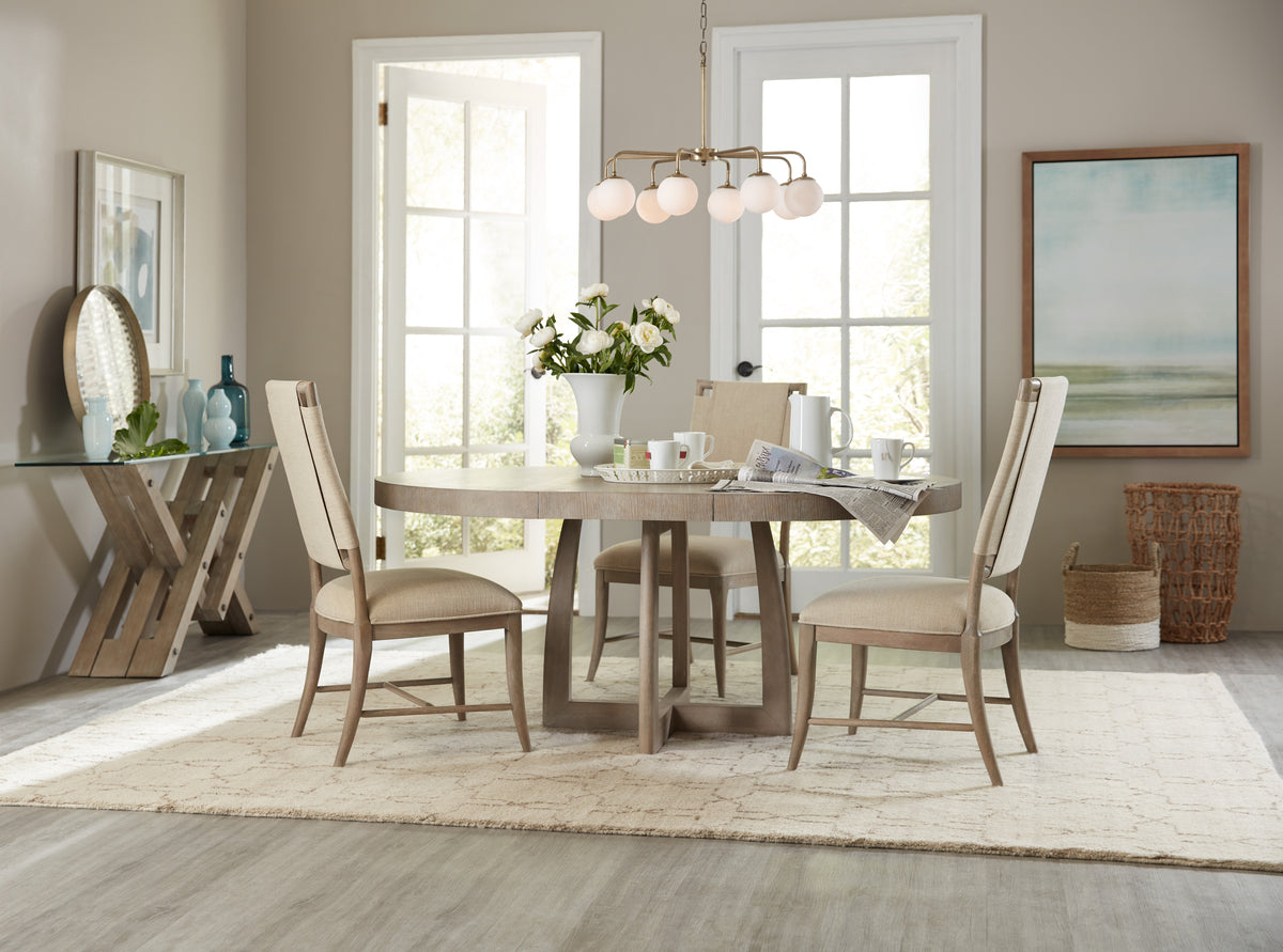a dining room table with chairs and a chandelier