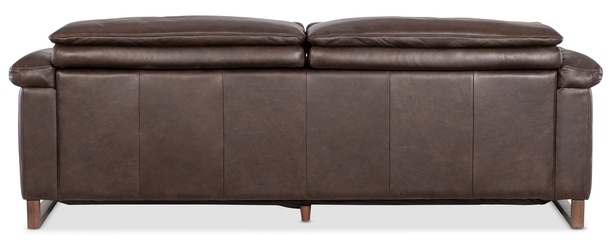 a brown leather couch with two pillows
