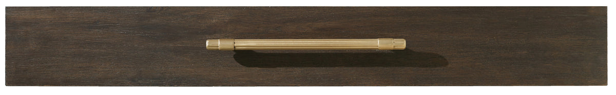 a wooden surface with a gold handle