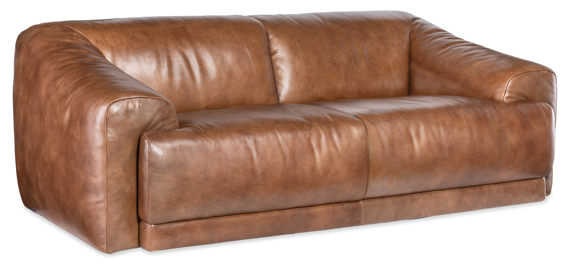 a brown leather couch with pillows