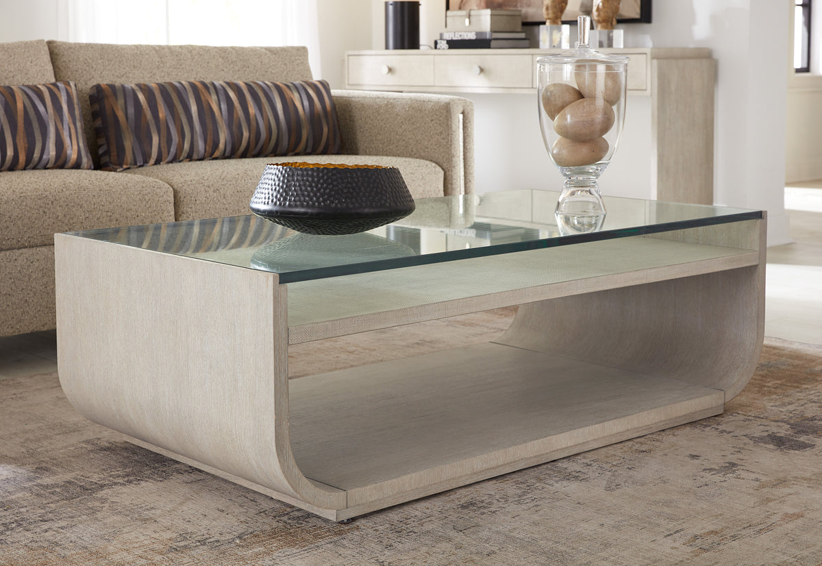 a glass coffee table with a bowl on top