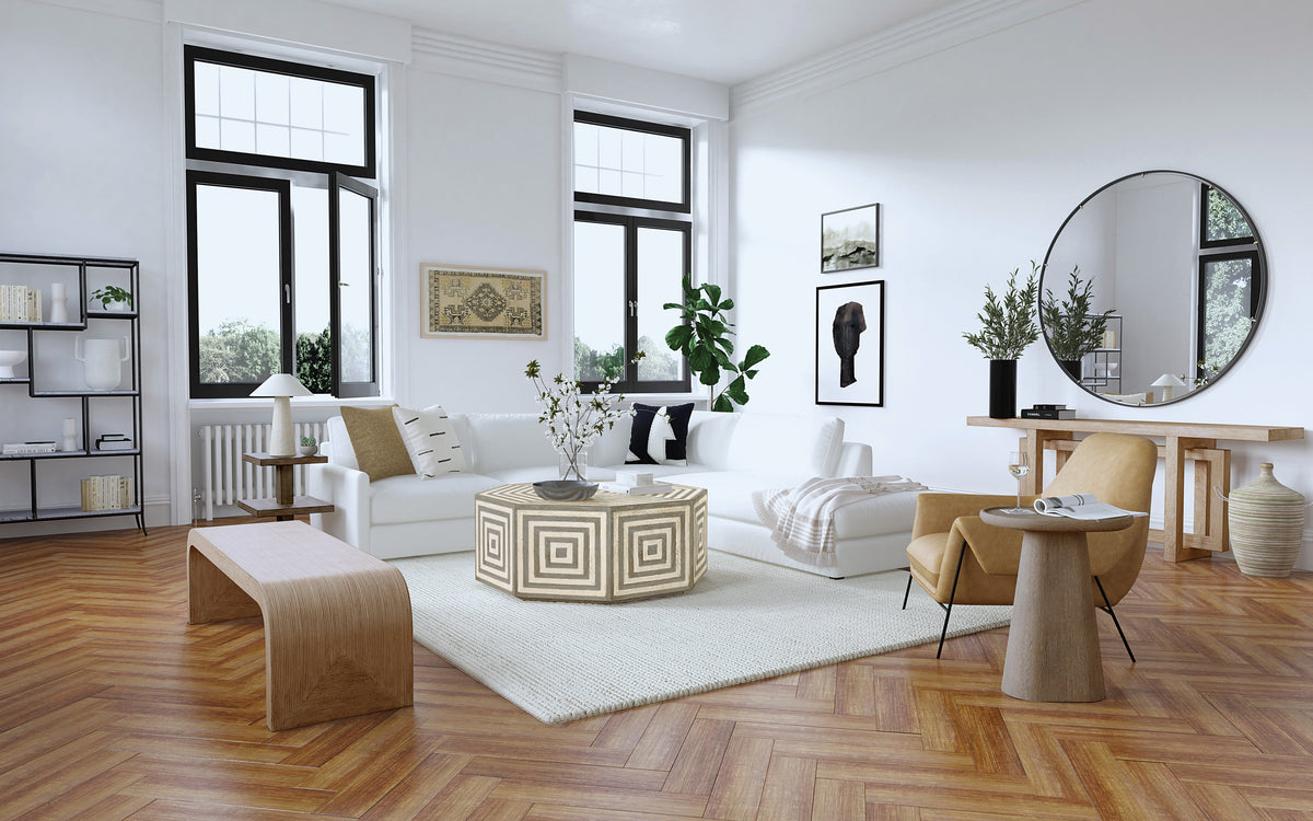 a living room with white furniture and a wood floor