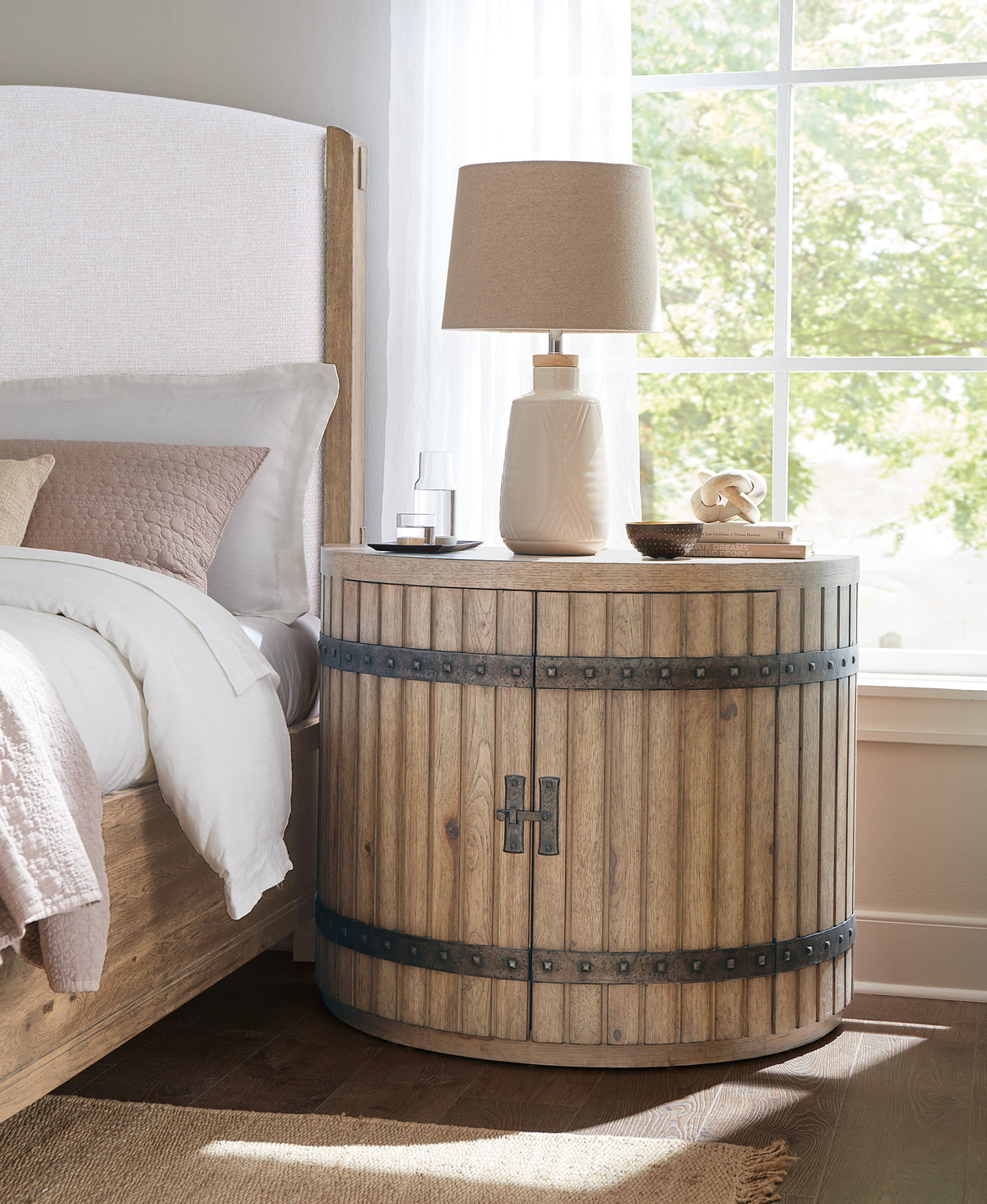 a wooden table next to a bed