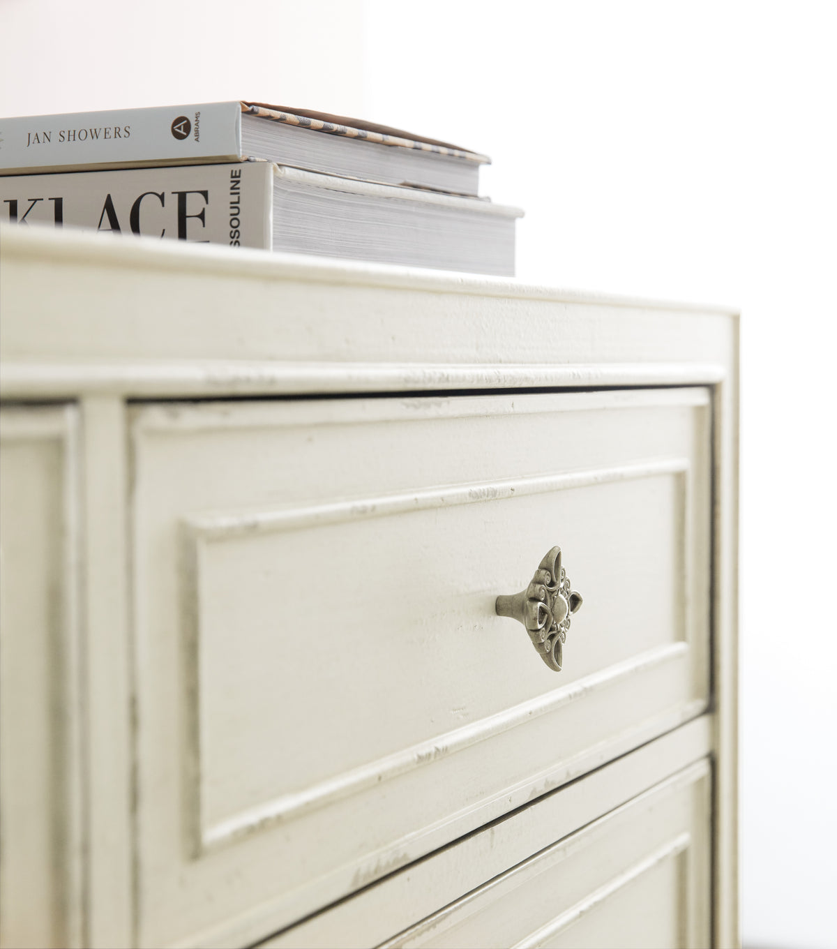 a white dresser with a book on top