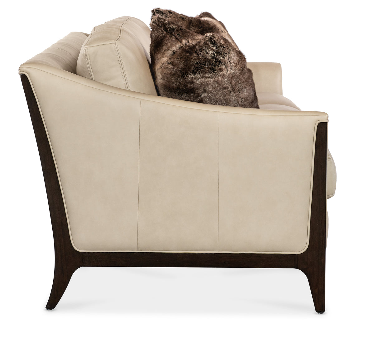 a white couch with a brown pillow on it
