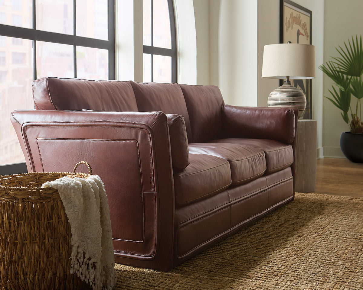 a brown leather couch in a room