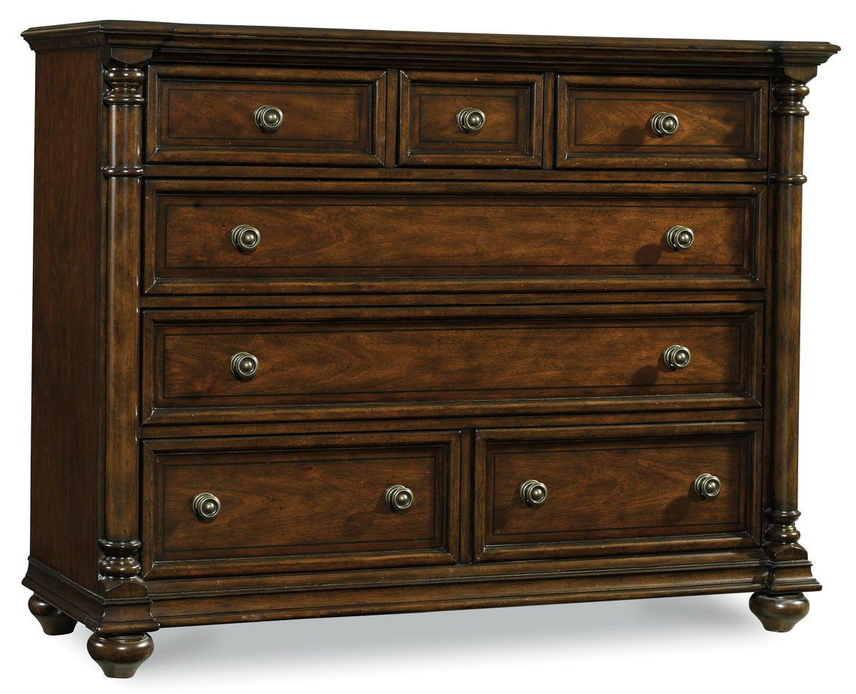 a brown dresser with silver knobs