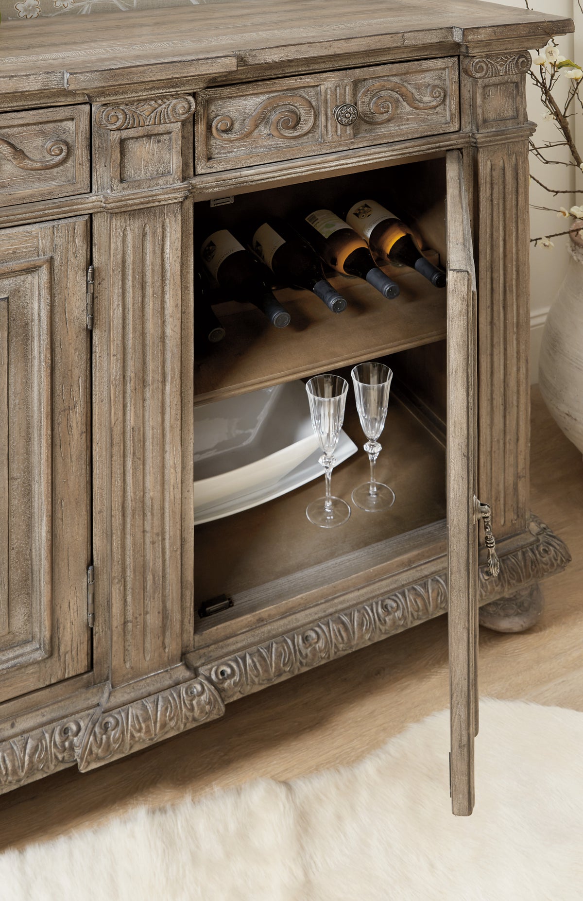 wine glasses and wine bottles in a cabinet