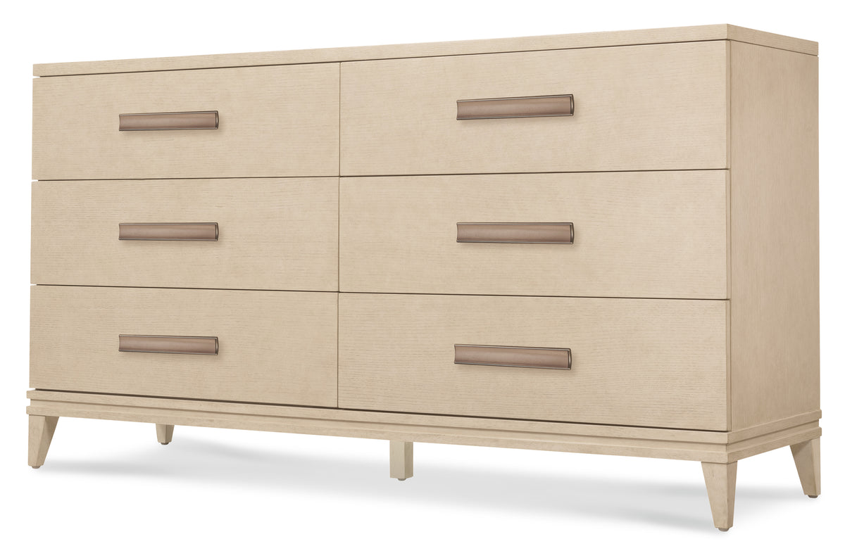 a white dresser with metal handles