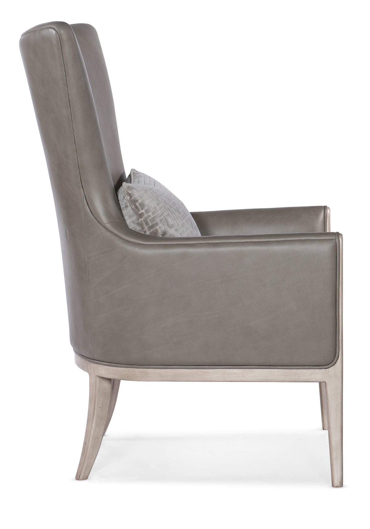 a grey leather chair with a pillow